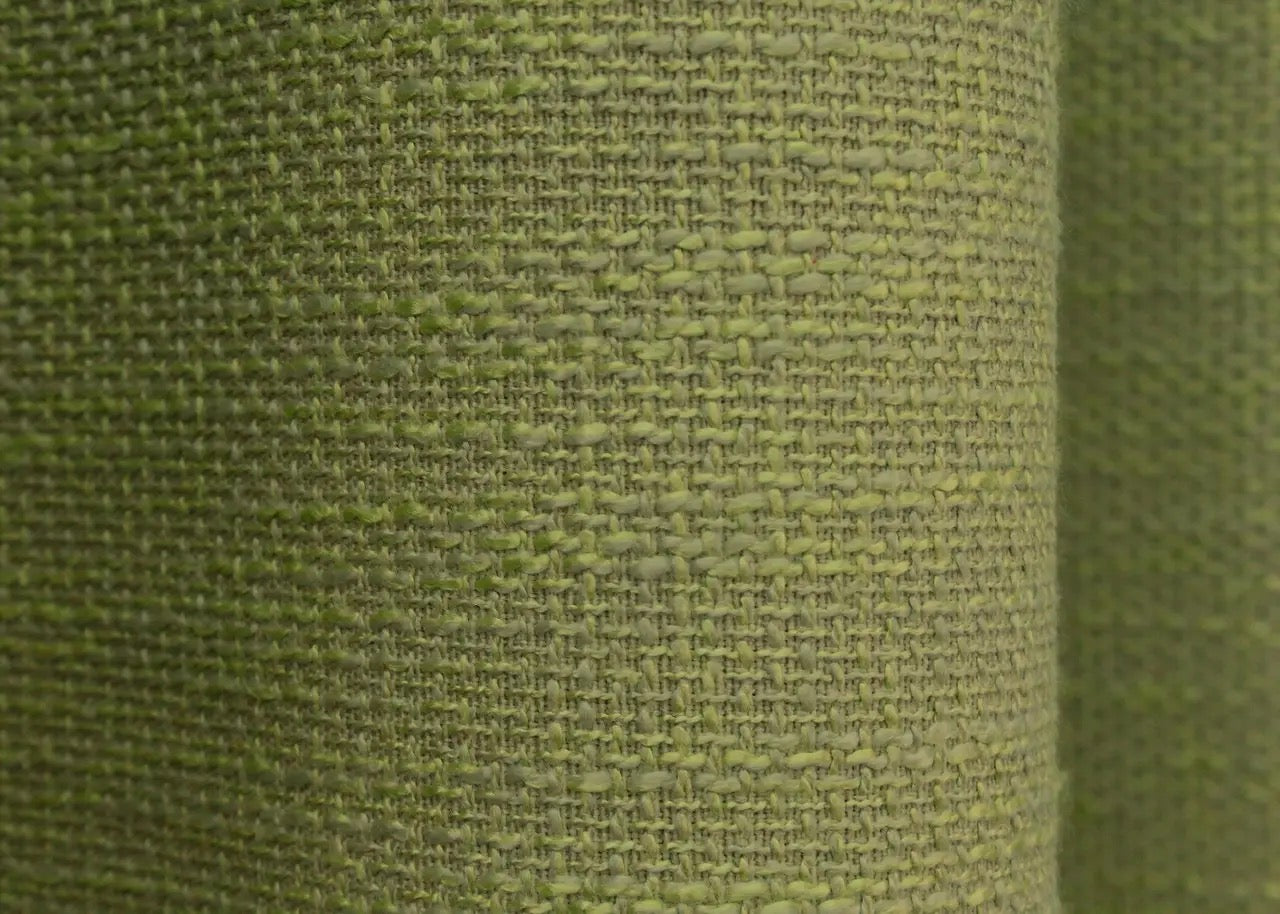 Modern light green linen curtains with a rustic woven texture, blending seamlessly with nature-inspired home decor.
