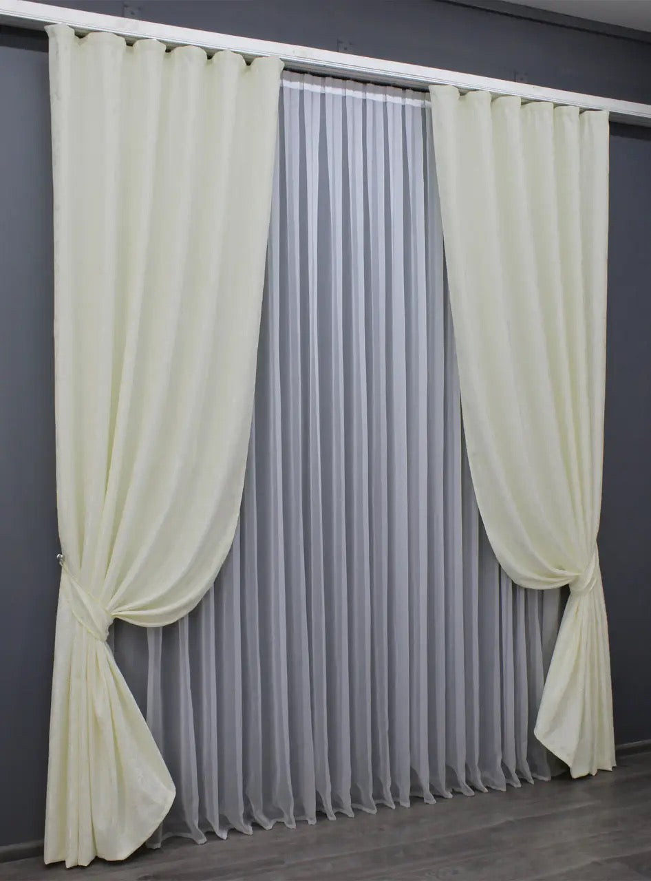 Elegant cream linen curtains with a luxurious pattern, enhancing brightness and refinement in living spaces.
