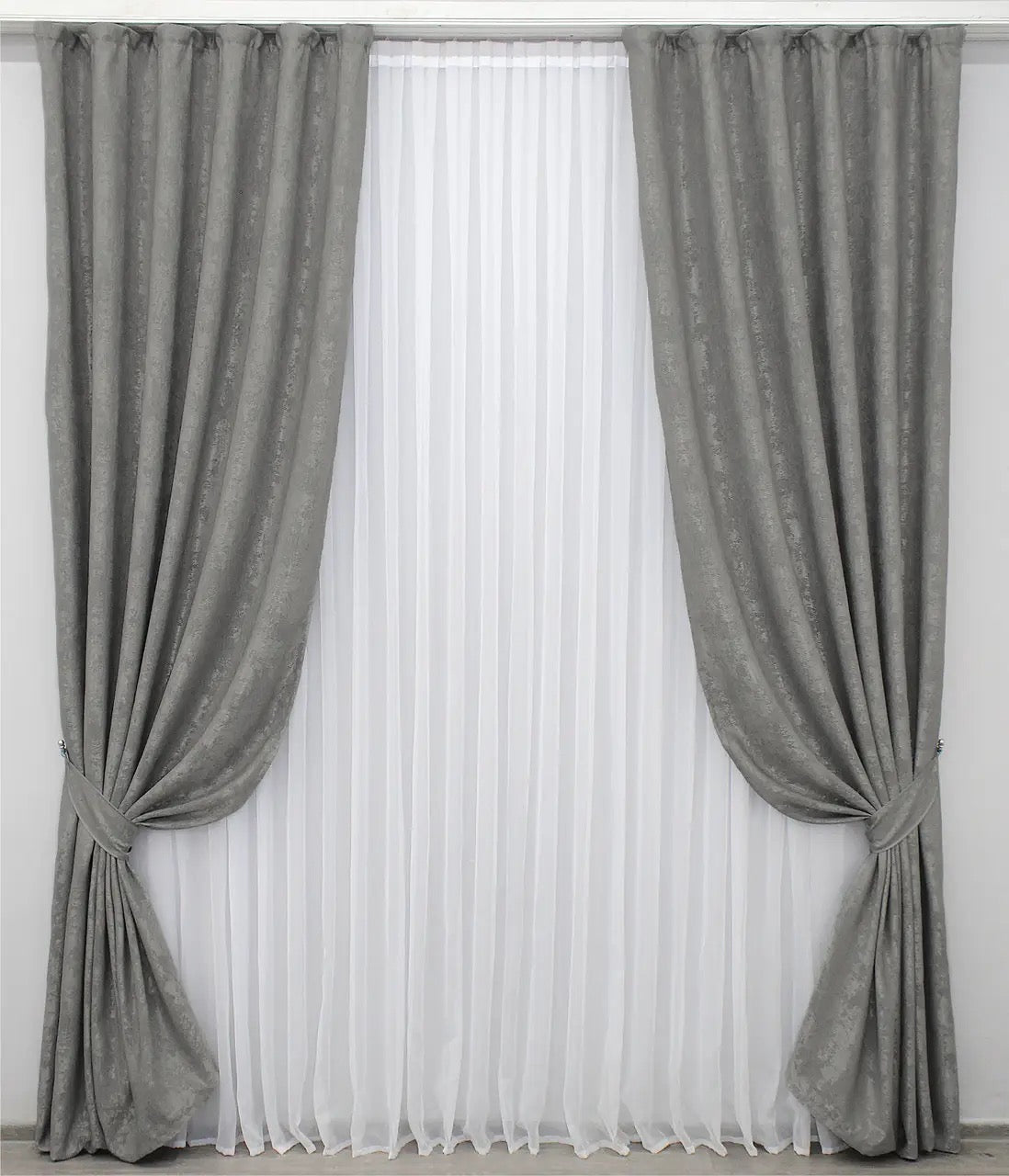 Luxury grey jacquard curtains featuring a textured design, enhancing living rooms and bedrooms with timeless elegance.
