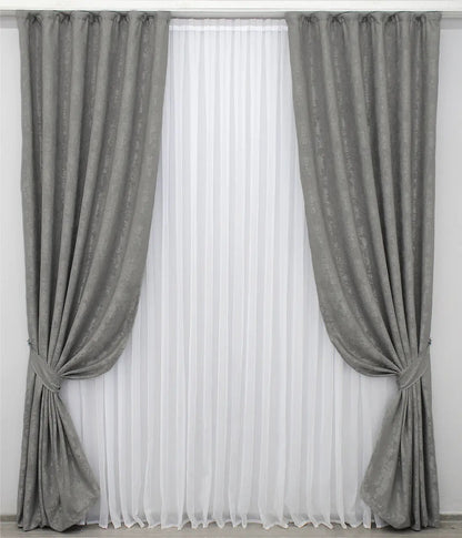 Luxury grey jacquard curtains featuring a textured design, enhancing living rooms and bedrooms with timeless elegance.
