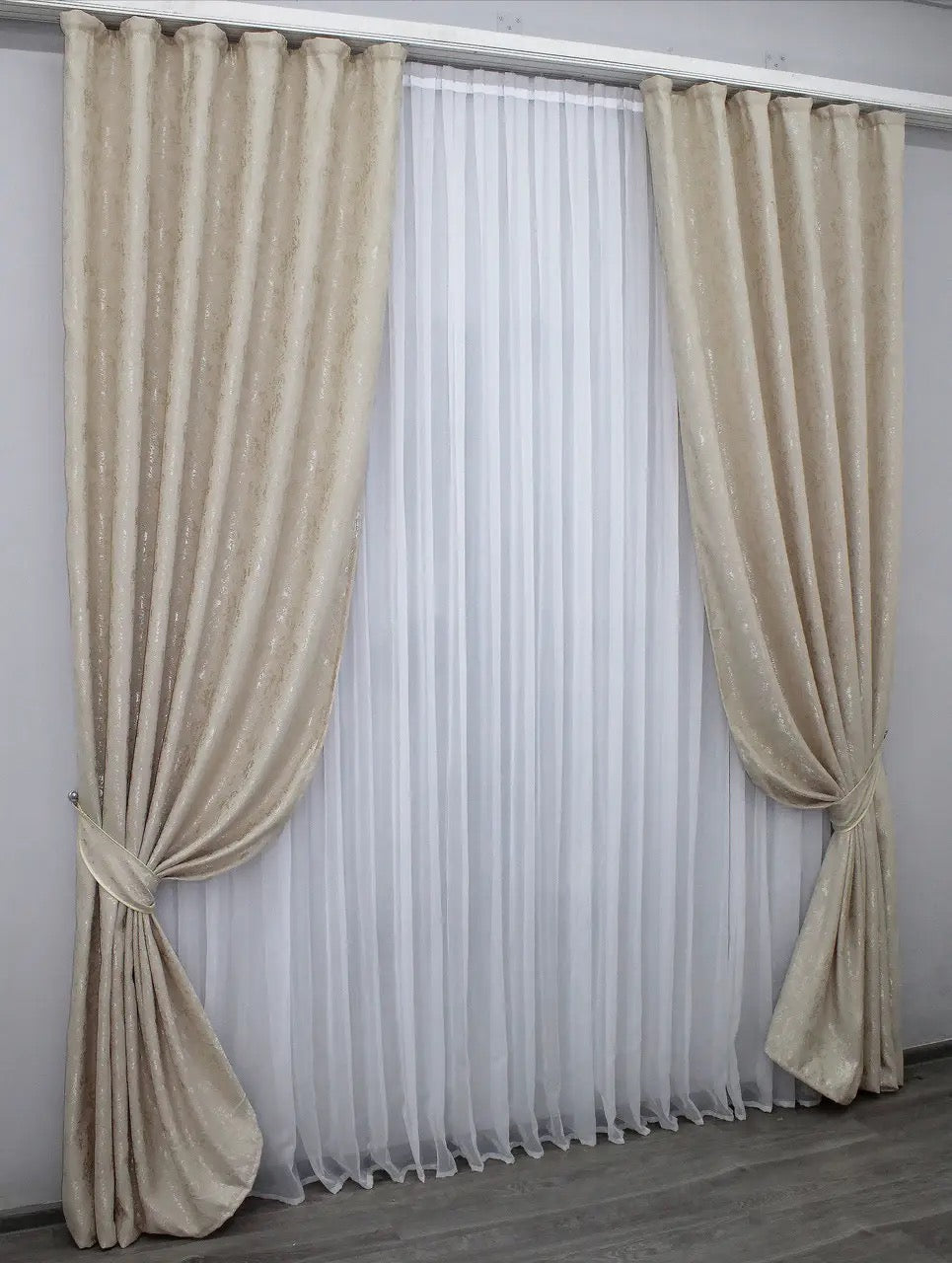 Elegant light beige linen curtains with a luxurious pattern, enhancing brightness and refinement in living spaces.
