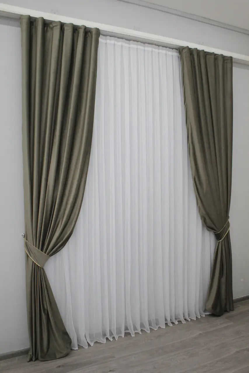 Elegant moss green velvet curtains, designed to add a refined touch to any room while providing light-blocking functionality.
