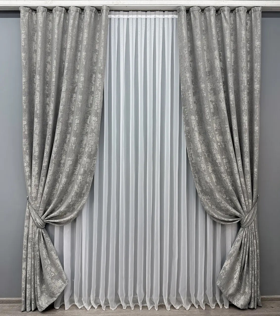 Stylish sterling silver curtains designed with a sophisticated sheen, ideal for bright and elegant living spaces.
