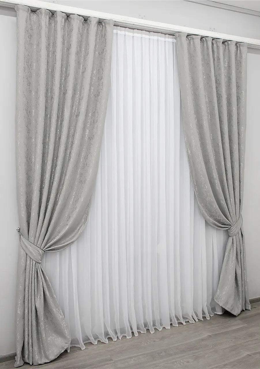 Luxury silver linen curtains with light-filtering fabric, enhancing brightness and sophistication.
