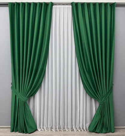 Elegant emerald green velvet drapes with thick, high-quality fabric, designed for a sophisticated home ambiance.
