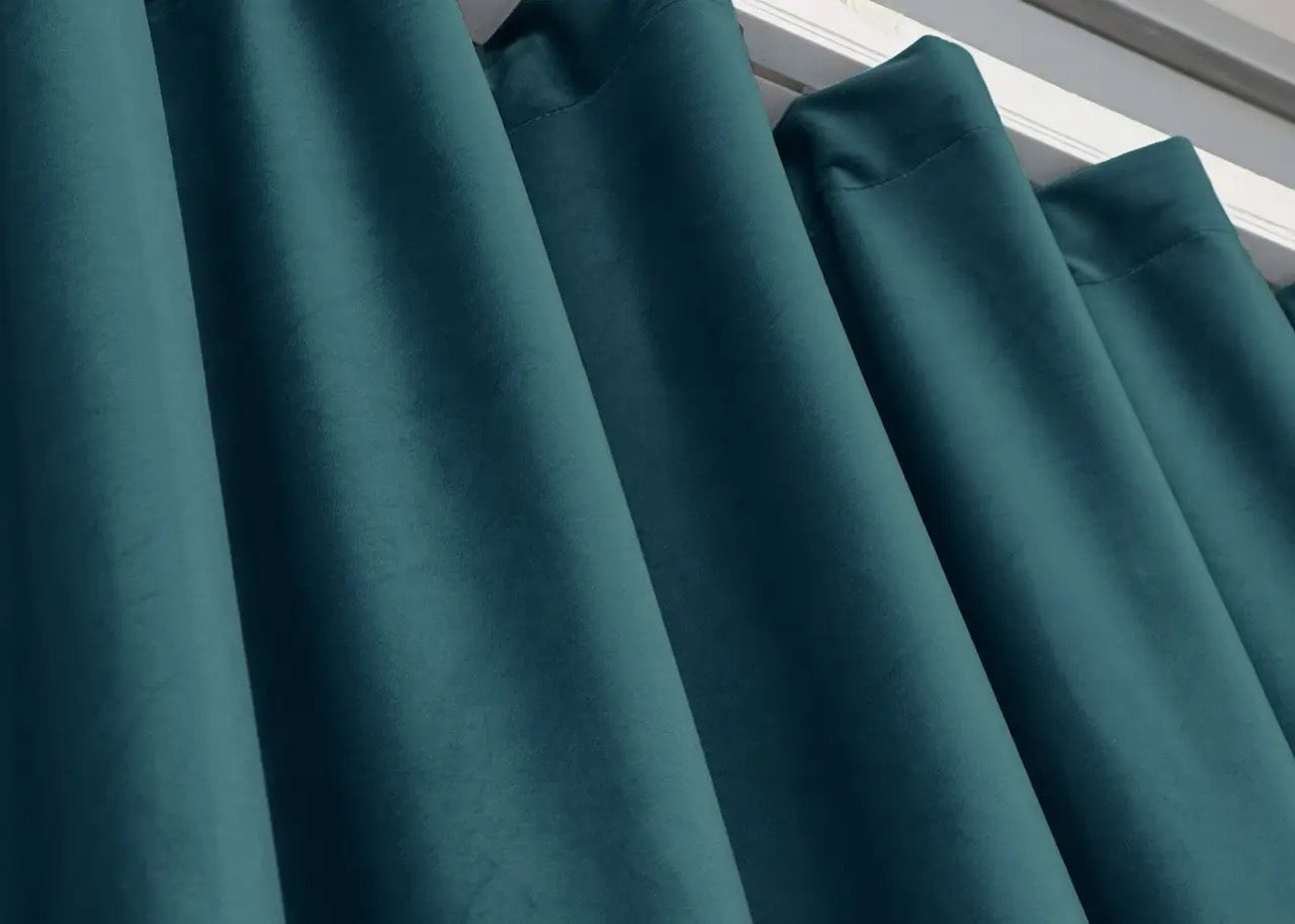 Emerald teal velvet curtain panels, featuring noise-absorbing properties and a smooth finish.
