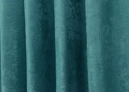 Rich peacock blue jacquard curtains with a woven pattern, creating a serene and inviting atmosphere in any room.
