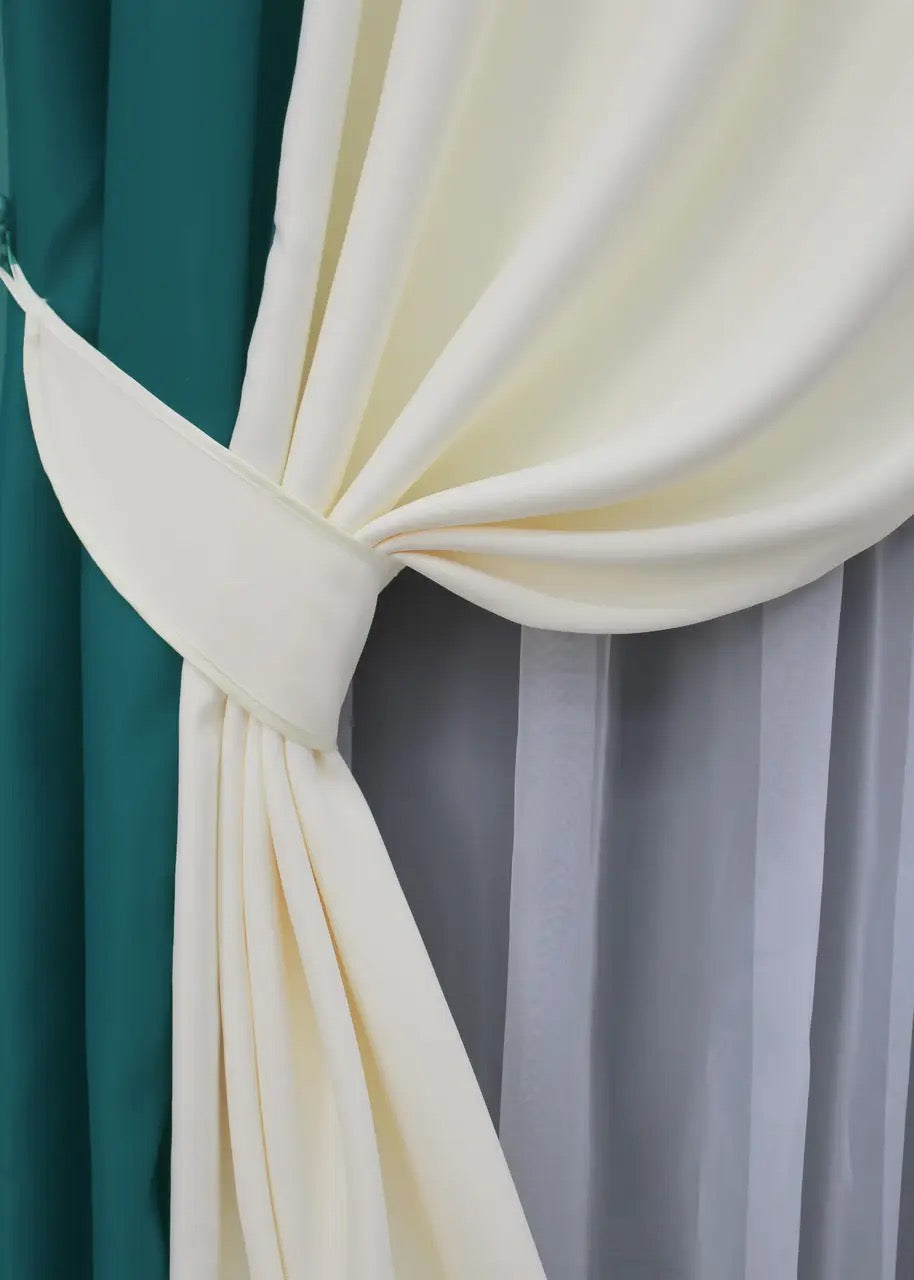 Sophisticated emerald and cream blackout curtains, creating a bold and elegant statement in your home.
