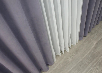 Muted lilac velvet curtains with a flowing drape, ideal for contemporary and romantic home décor.
