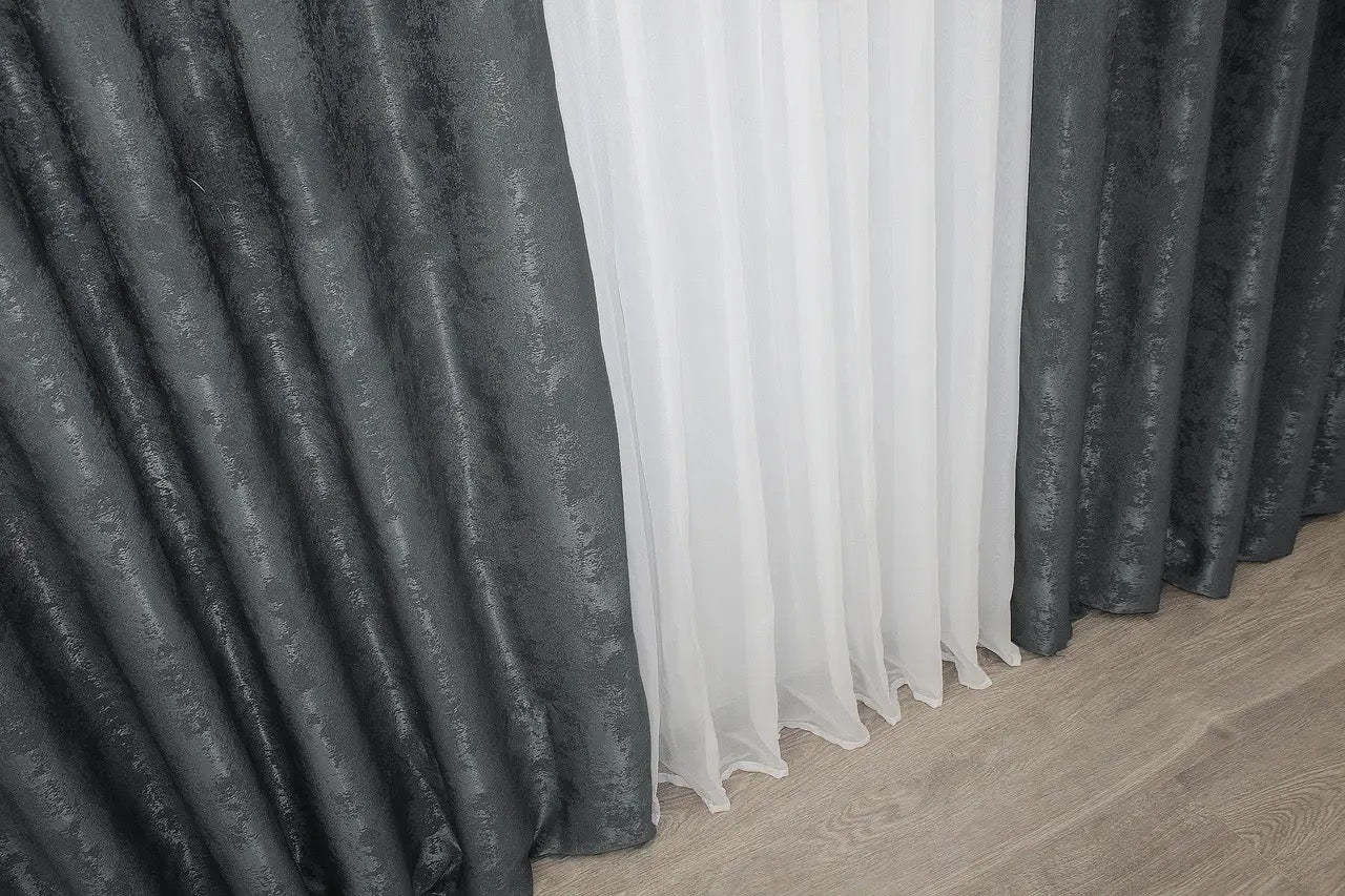 High-quality light grey curtains with a stylish jacquard texture, adding depth and dimension to bedroom or living room interiors.
