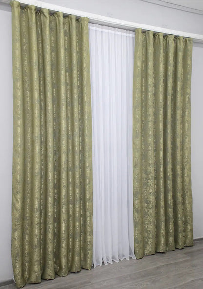 Rich olive jacquard curtains with a textured woven pattern, creating a luxurious yet warm and inviting atmosphere.
