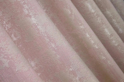 Soft pale pink jacquard curtains with a delicate woven pattern, creating a warm and inviting atmosphere.
