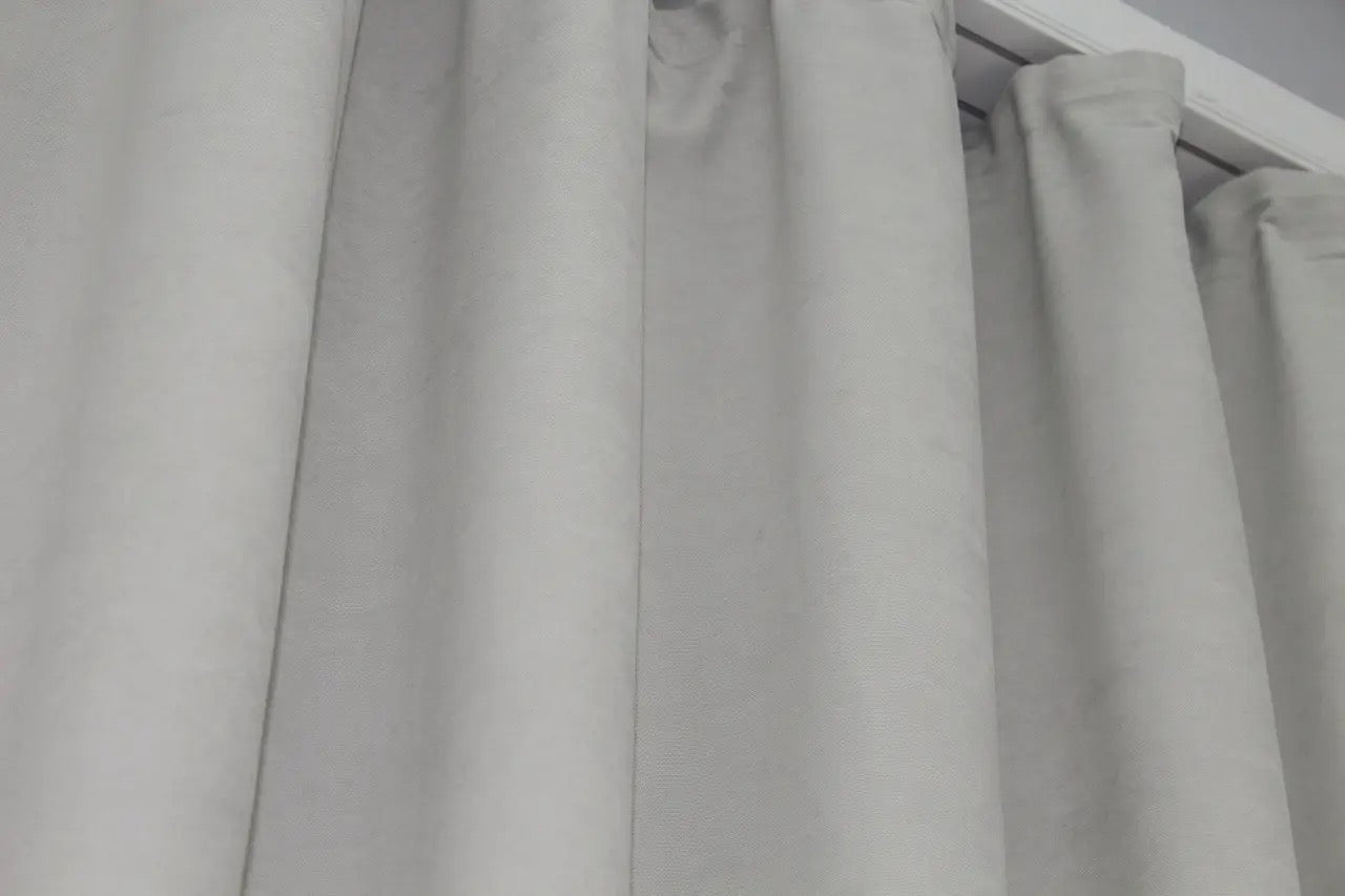 Versatile neutral grey microvelvet curtains with a flowing drape, ideal for bright and airy interiors.
