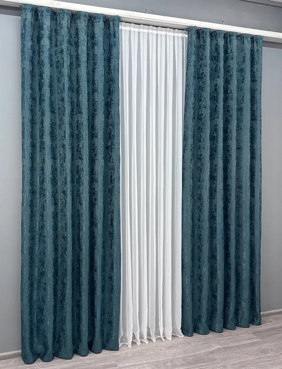 Set of two azure blue jacquard curtain panels with matching tie-backs, providing a polished and elegant window treatment.
