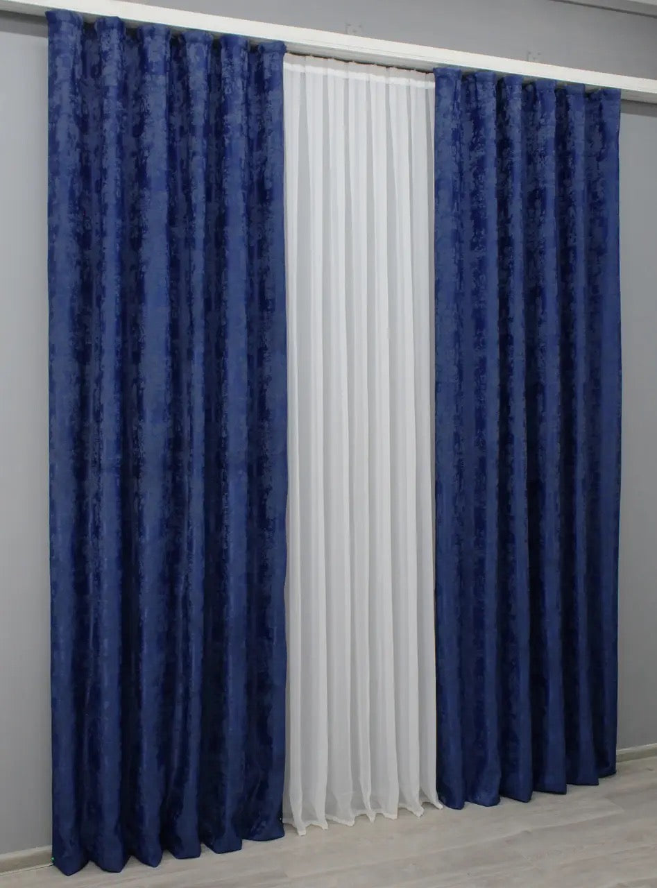 Set of two blue jacquard curtain panels with matching tie-backs, offering a polished and luxurious window treatment.
