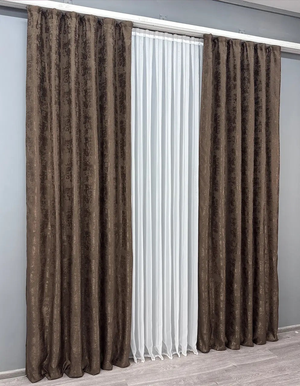 Set of two brown jacquard curtain panels with matching tie-backs, providing a polished and elegant window treatment.
