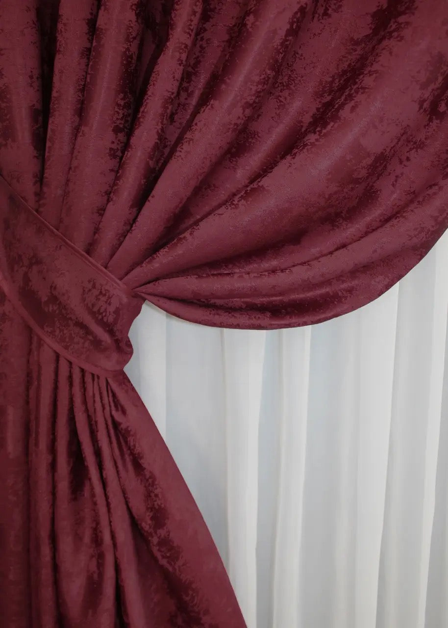 Set of two burgundy jacquard curtain panels with matching tie-backs, providing a polished and refined window treatment.
