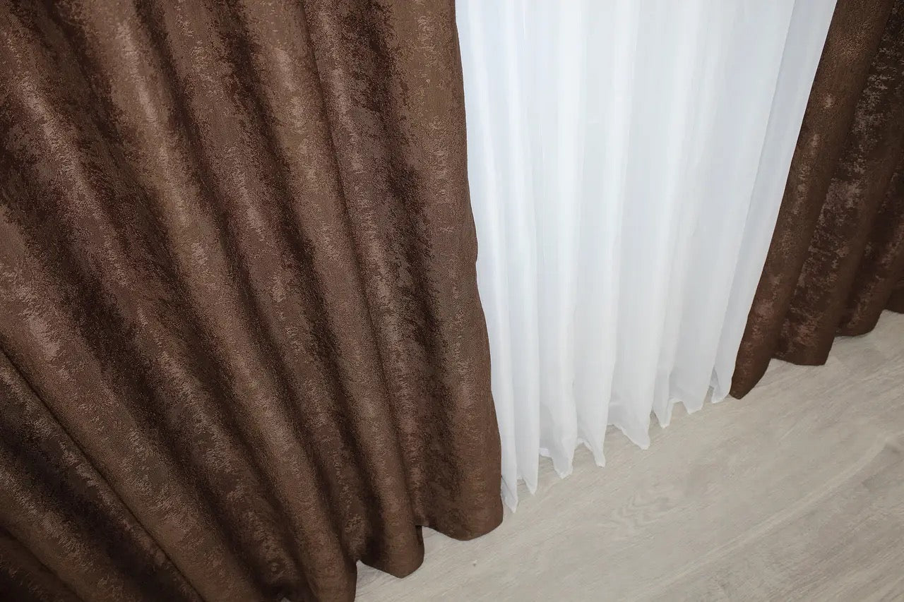 High-quality chocolate brown jacquard curtains featuring intricate woven patterns and matching tie-backs for a refined look.
