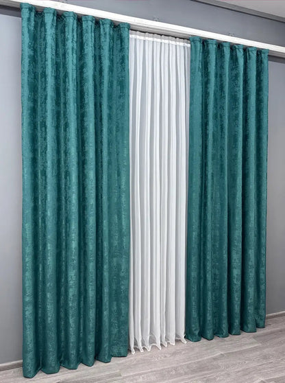 Set of two dark teal jacquard curtain panels with matching tie-backs, offering a polished and elegant window treatment.
