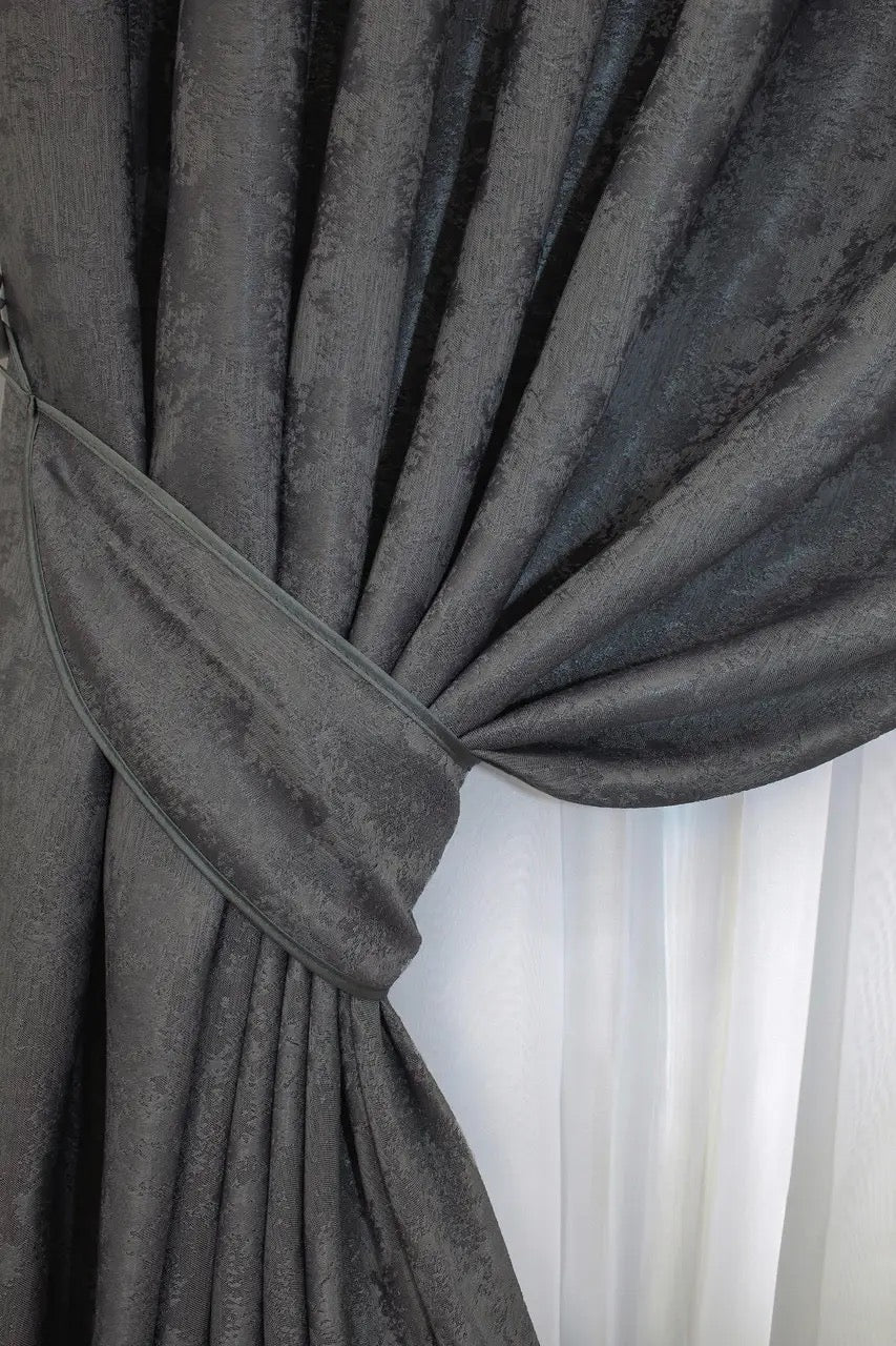 Set of two graphite dark grey jacquard curtain panels with matching tie-backs, offering a polished and elegant window treatment.
