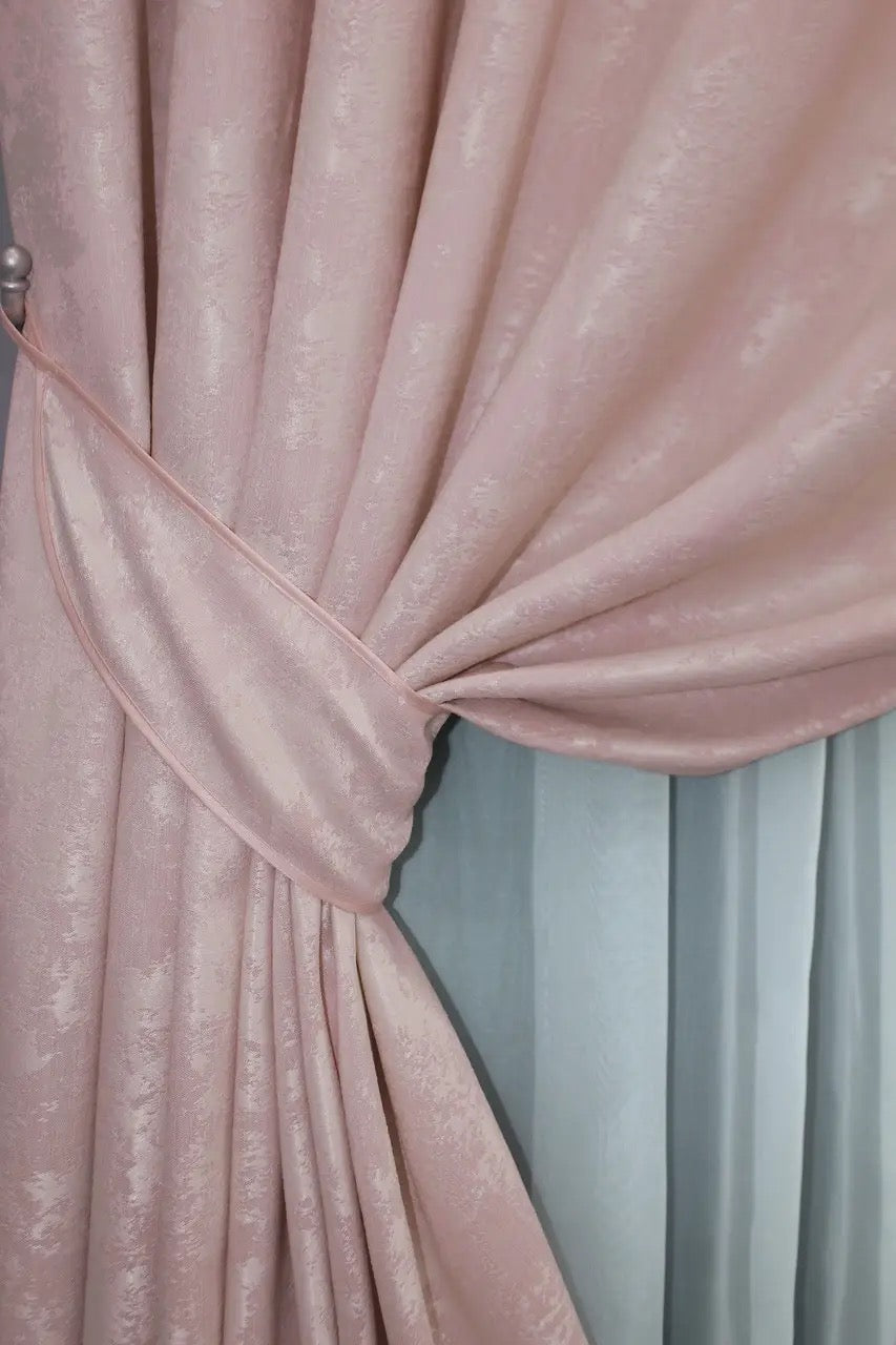 Set of two pale pink jacquard curtain panels with matching tie-backs, providing a polished and elegant window treatment.
