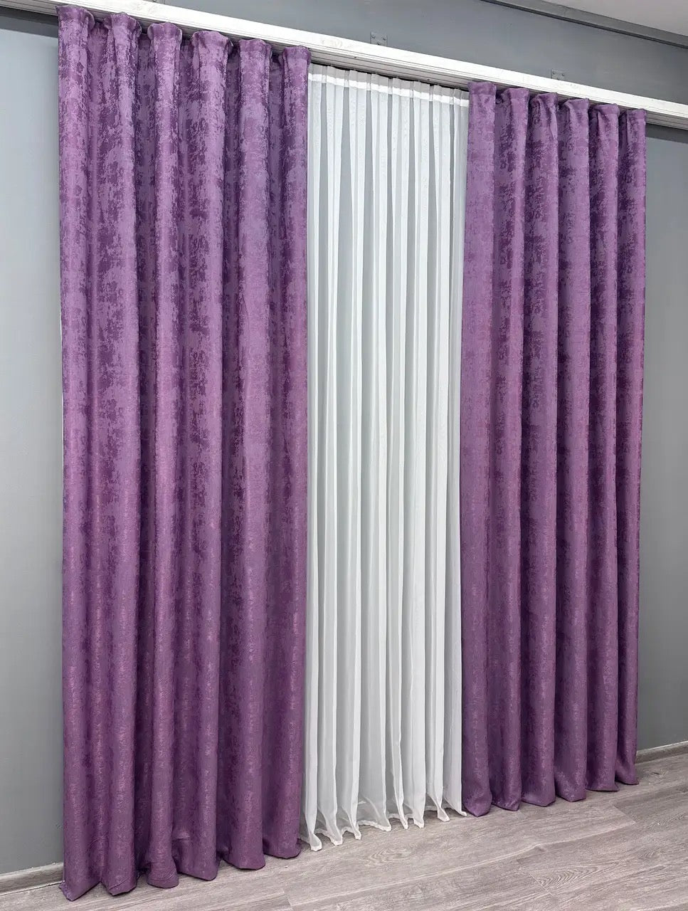 Set of two periwinkle lavender jacquard curtain panels with matching tie-backs, offering a polished and elegant window treatment.
