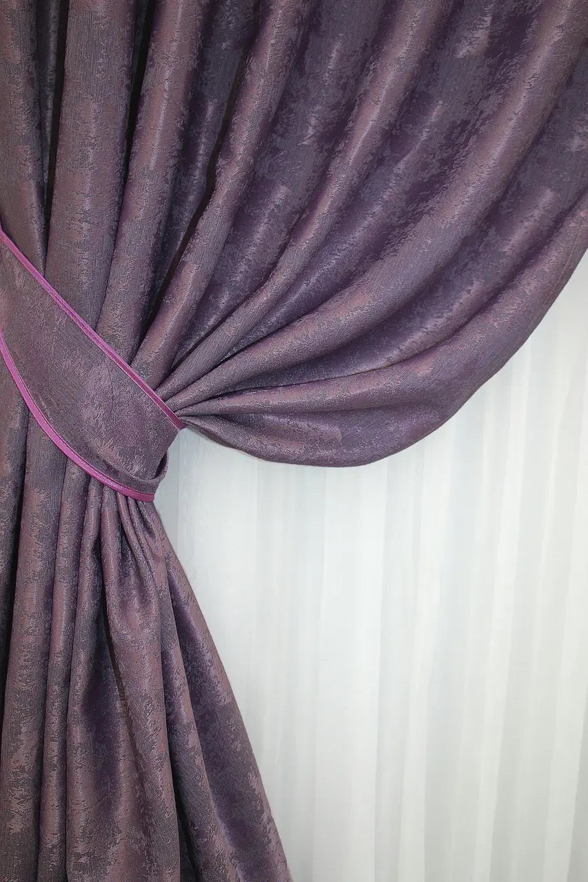 Set of two purple jacquard curtain panels with matching tie-backs, offering a polished and refined window treatment.
