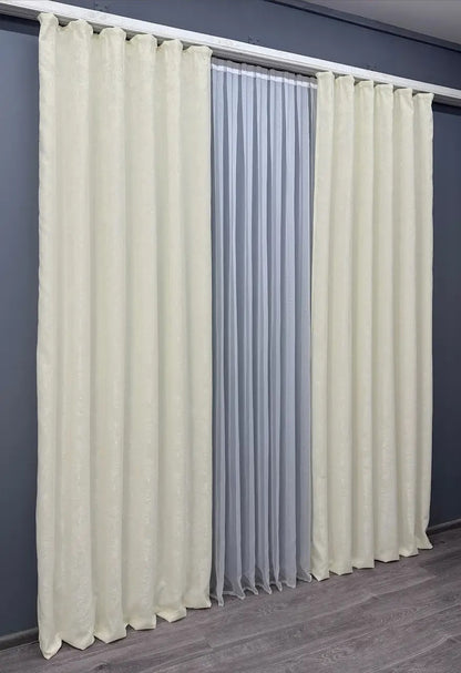 Set of 2 cream jacquard curtain panels, designed to create a soft and inviting atmosphere while maintaining privacy.
