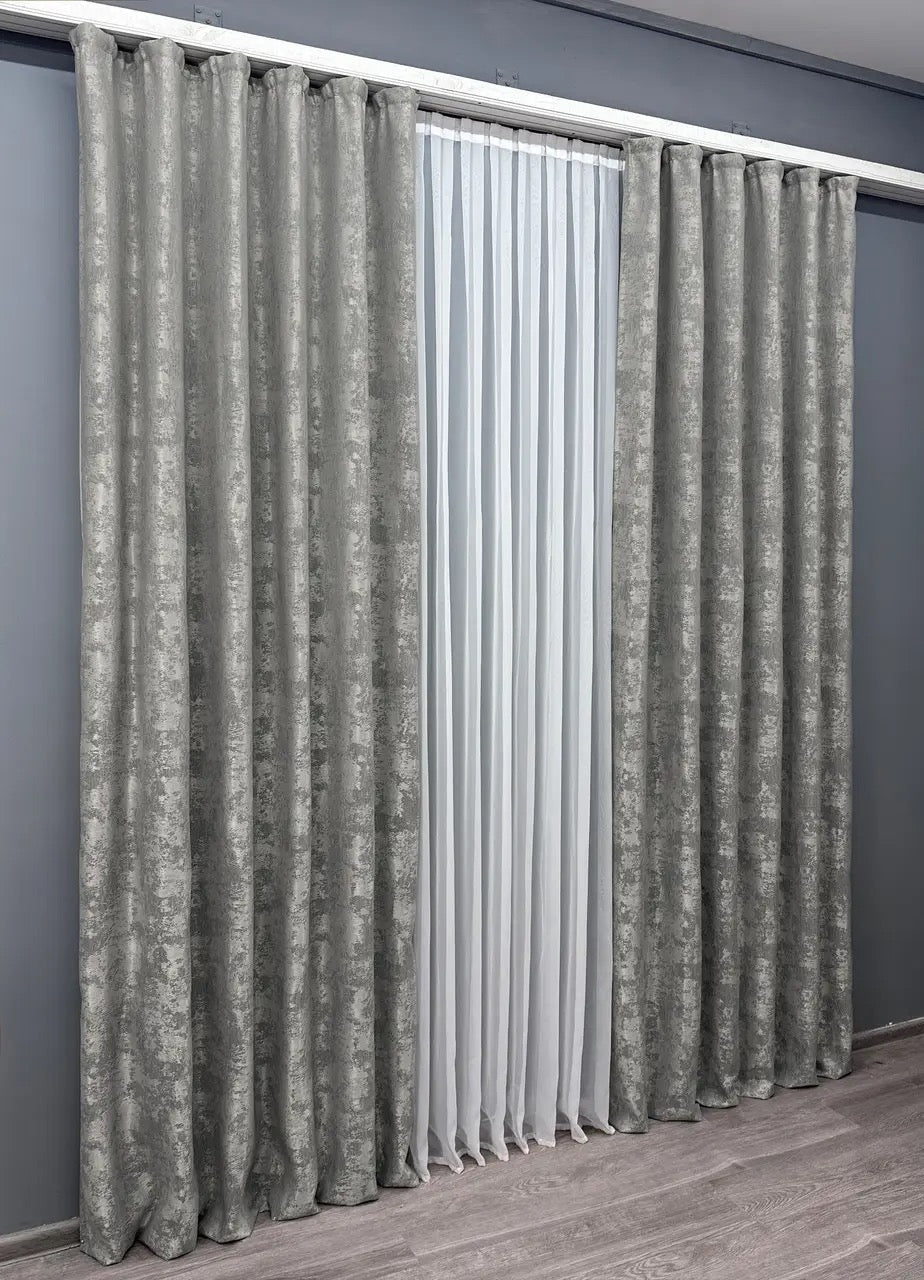 Set of 2 silver jacquard curtain panels, designed to create a contemporary and luxurious atmosphere while maintaining privacy.
