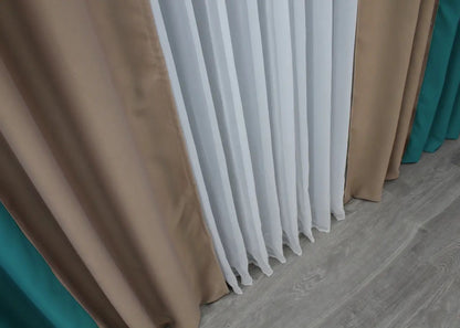 Two-tone emerald green (often called Hunter Green) and dark beige (or Camel) blackout curtains designed for a sophisticated and contemporary space.
