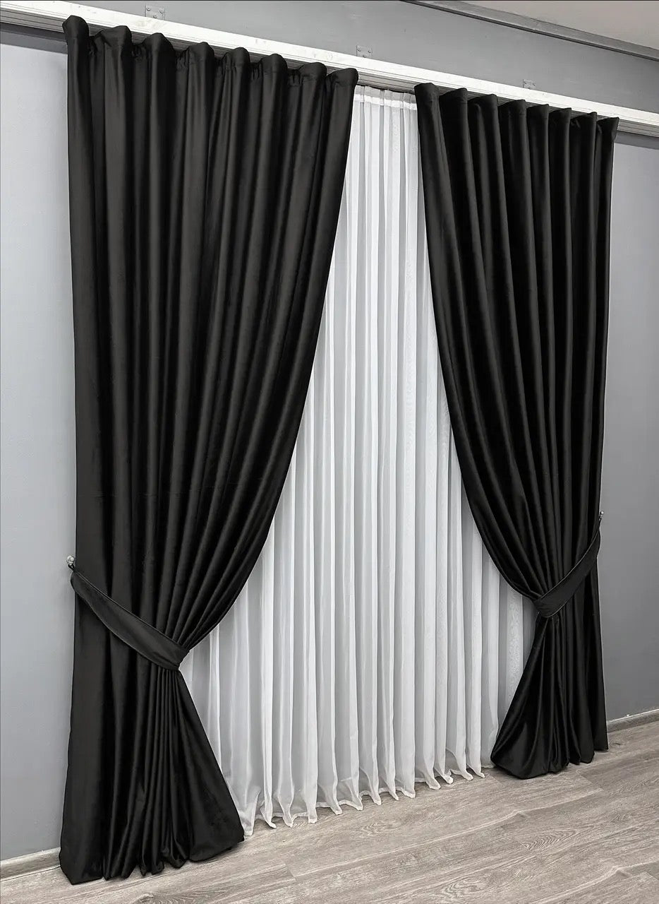 Jet black velvet blackout curtains, adding a touch of elegance and style to any living space.
