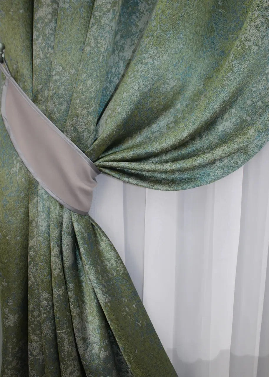 Breathable and light-filtering green and turquoise linen curtains, ideal for creating a tranquil living space.
