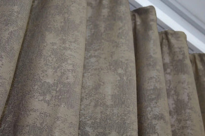 Elegant beige-grey curtains with a soft, neutral hue, allowing natural light to filter through gently.
