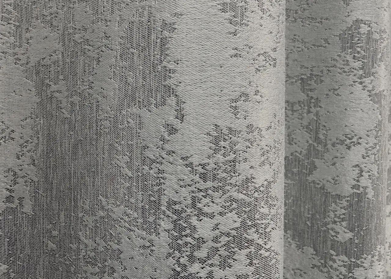 Luxurious ice silver curtains with a soft shimmer, providing depth and sophistication to any home setting.
