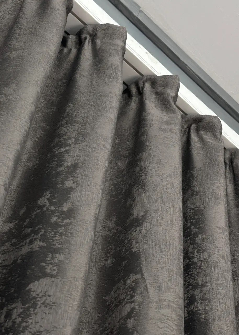 Luxurious dark grey curtains with an intricate jacquard weave, adding depth, elegance, and style to any space.
