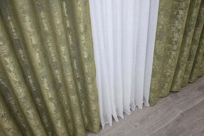 Non-blackout olive jacquard curtains that provide privacy while letting soft natural light filter through.
