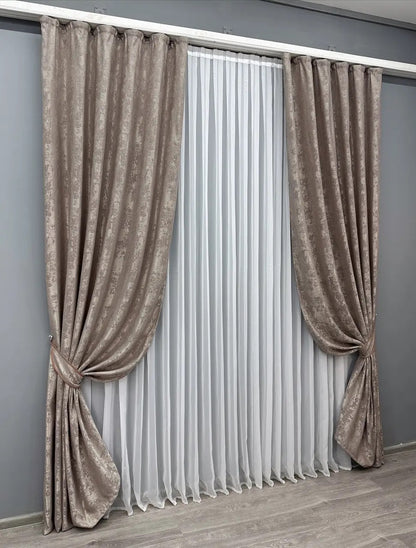 Stylish taupe curtains with a woven jacquard pattern, adding depth and elegance to living spaces.
