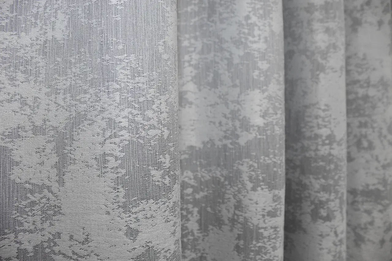 Luxurious frost grey curtains with a shimmering jacquard weave, adding depth and brightness to interiors.
