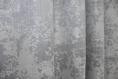 Luxurious frost grey curtains with a shimmering jacquard weave, adding depth and brightness to interiors.
