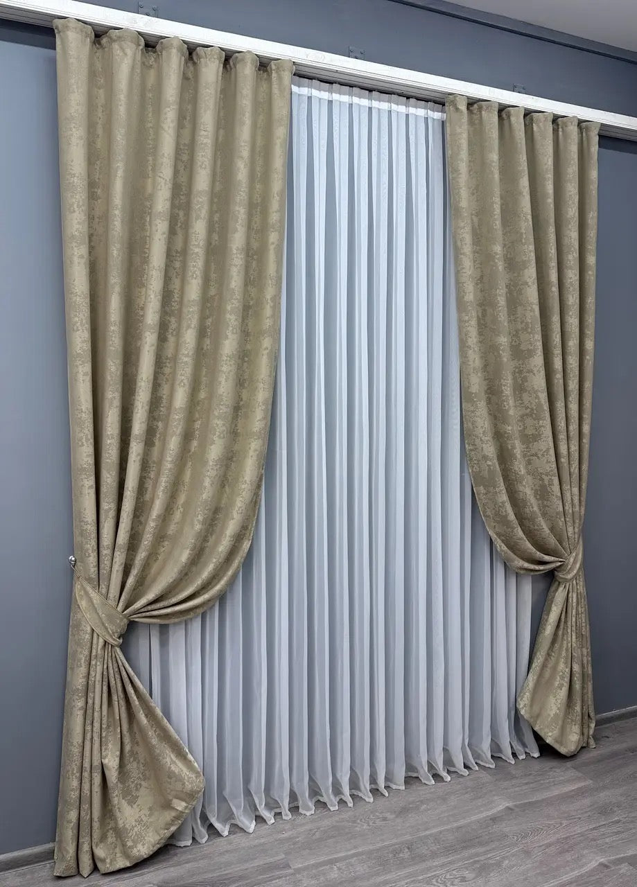 Set of two sandy brown jacquard curtain panels with tie-backs, providing a polished and cozy window treatment.
