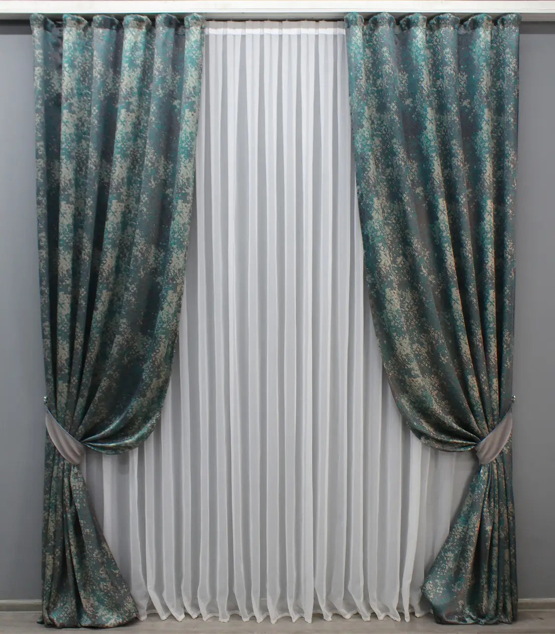 Premium linen drapes in deep teal and grey, with a refined marble texture for a contemporary home aesthetic.
