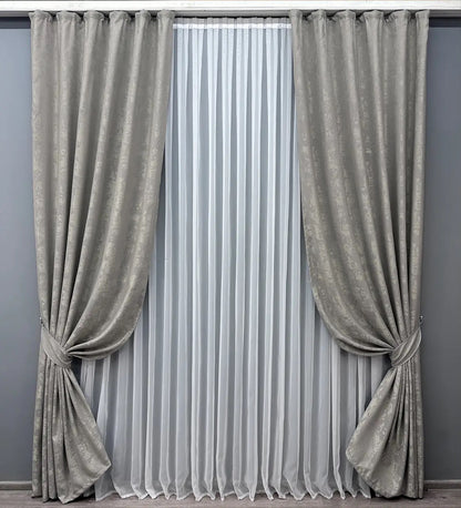 Luxury light grey jacquard curtains with intricate woven patterns, adding sophistication to modern and classic interiors.
