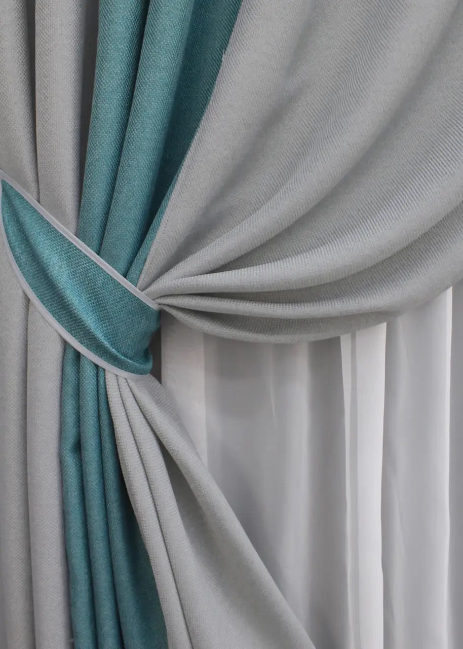 High-quality linen curtains in light grey and turquoise, with a sophisticated and timeless two-tone design, perfect for creating a serene and inviting ambiance.
