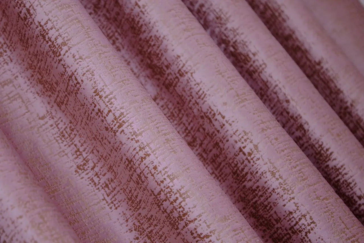 Timeless pink and gold velvet drapes with 90% light-blocking capability, creating a serene and luxurious environment.
