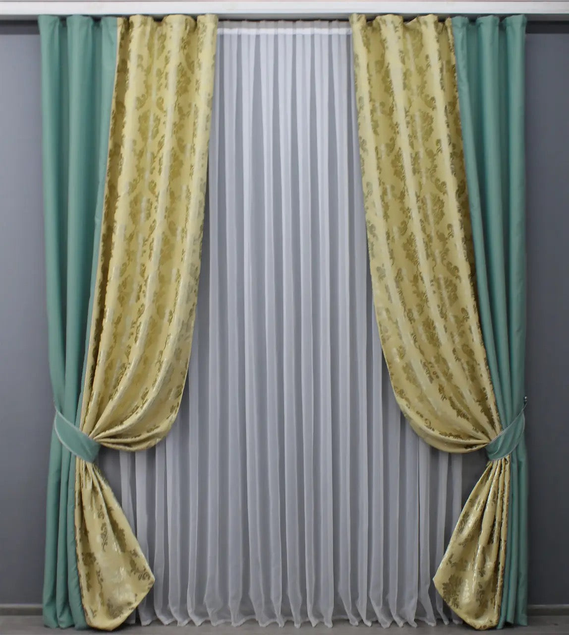 Premium turquoise and beige blackout curtains providing superior light-blocking functionality and a smooth, luxurious drape.
