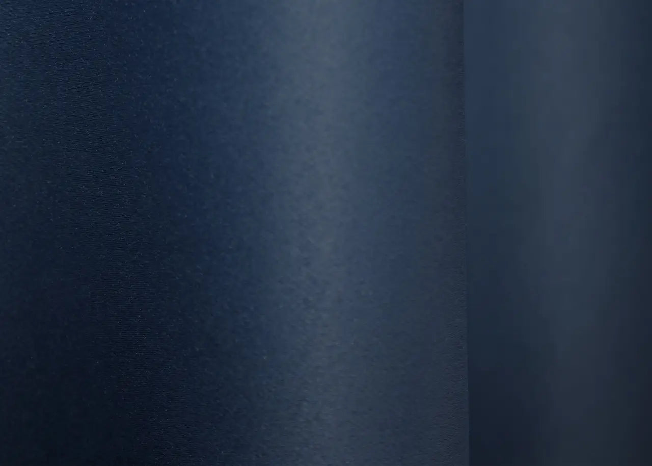 Luxury blue blackout curtains offering warmth and a polished aesthetic.
