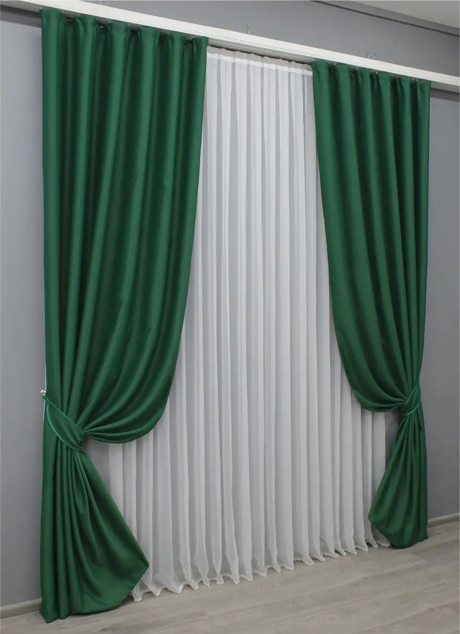 Midnight green blackout curtains with a plush and elegant texture.
