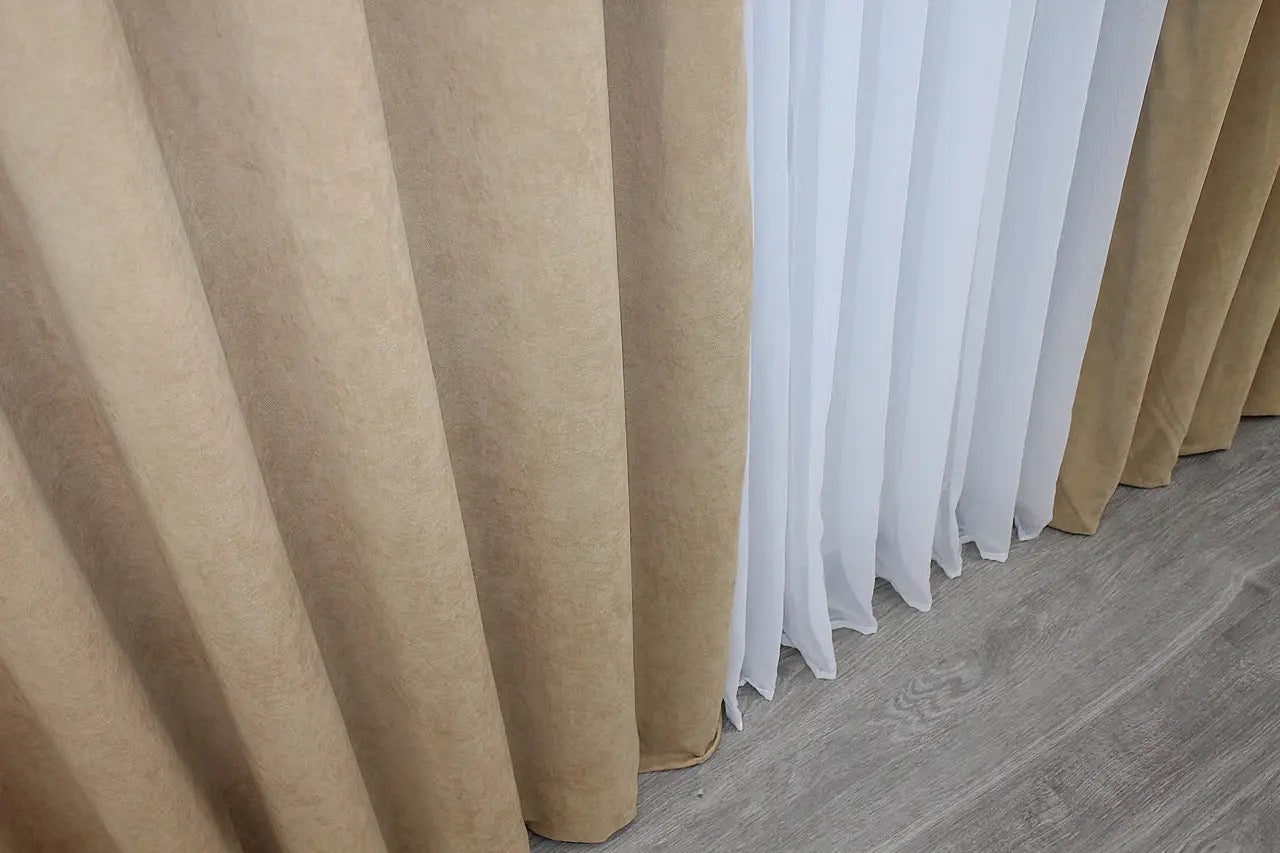 Beige microvelvet curtains with 70% light filtering, providing privacy while allowing soft illumination.
