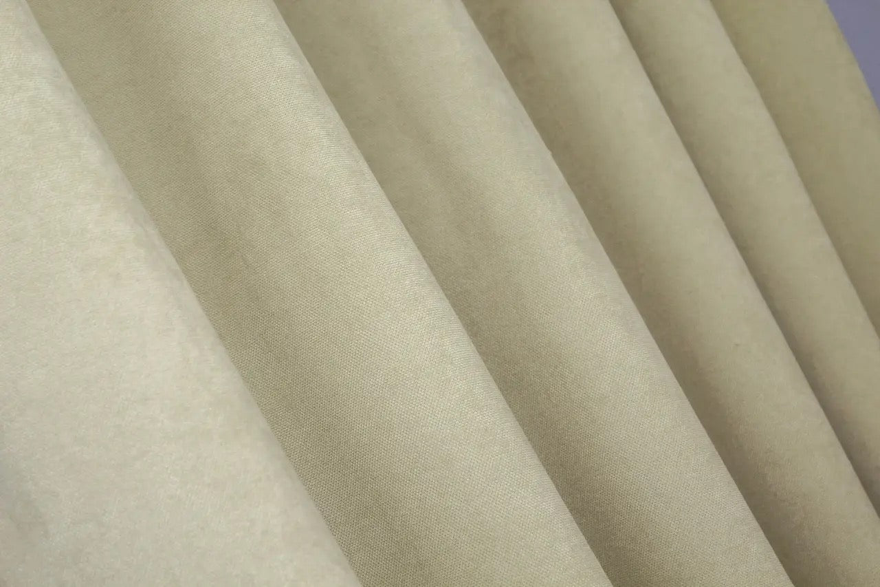 Cream microvelvet curtains with 70% light filtering, providing privacy while allowing soft illumination.
