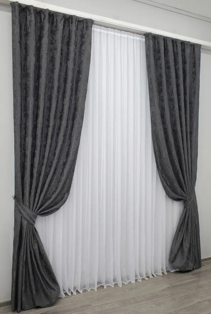 Stylish graphite dark grey jacquard curtains designed for privacy and light filtering, allowing soft natural light to create a calm ambiance.
